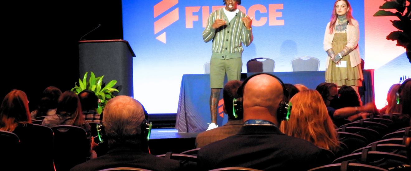 An attendee at Digital Pharma East 2024 at the Pennsylvania Convention Center uses a translation device during a keynote session.