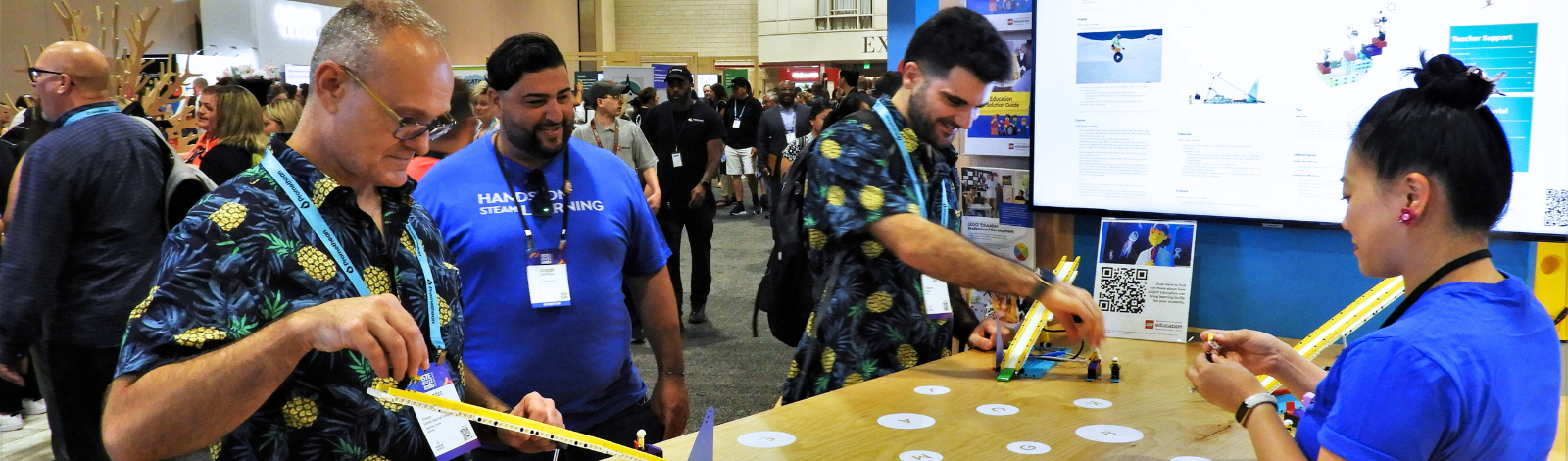 Attendees at ISTE 2023 interact with learning toys at an exhibitor booth.